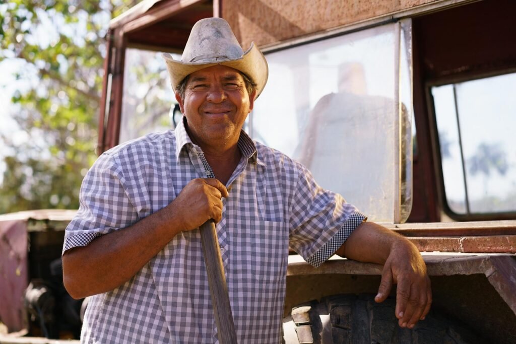 portrait-happy-man-farmer-leaning-on-tractor-looki-P2VQUG3.jpg